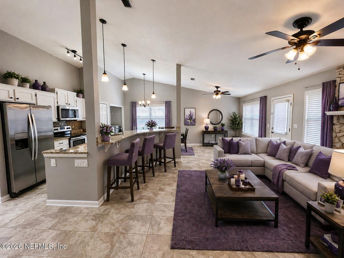 7820 Collins Ridge Boulevard East Jacksonville, FL 32244 - Photo 3 of 27 a living room with furniture kitchen view and a chandelier