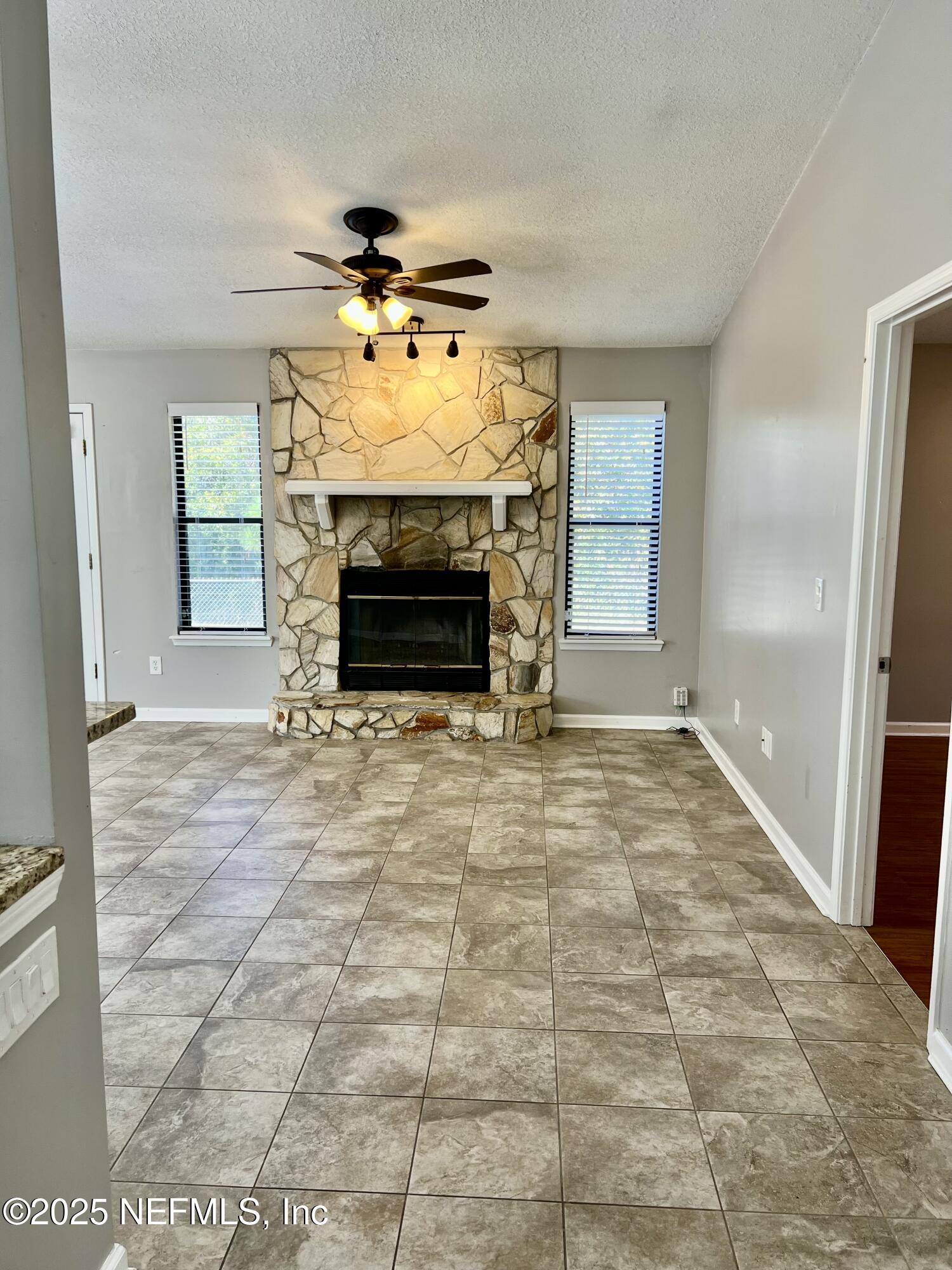 7820 Collins Ridge Boulevard East Jacksonville, FL 32244 - Photo 10 of 27 a view of an empty room with a fireplace