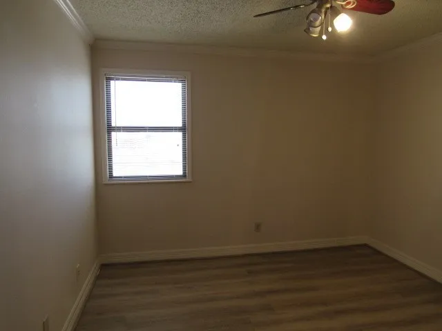 a view of a small space with wooden floor and a window