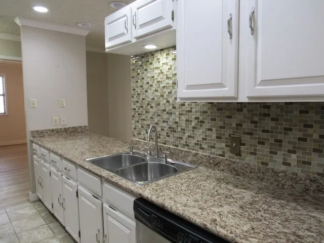 a kitchen with a sink and cabinets