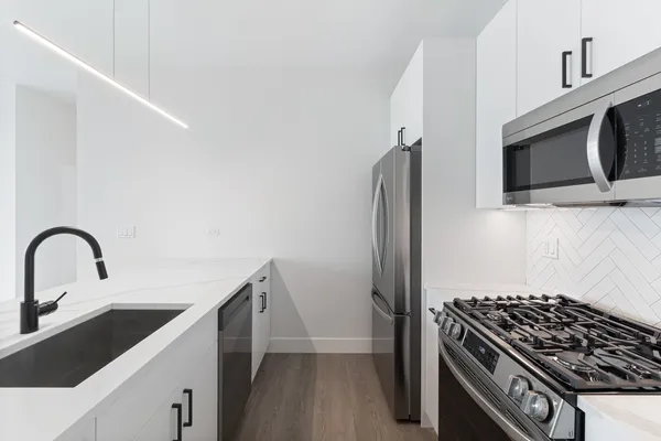a kitchen with a sink and stainless steel appliances