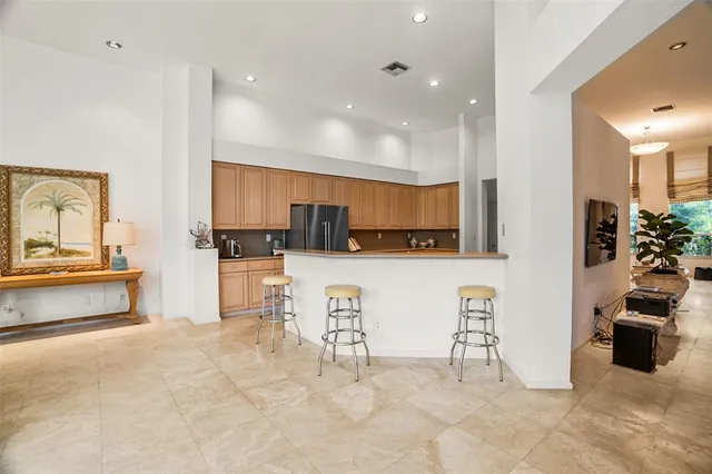 a kitchen with stainless steel appliances granite countertop a refrigerator sink and cabinets