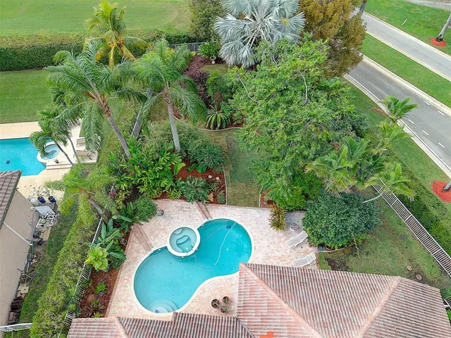 an aerial view of a house with a yard