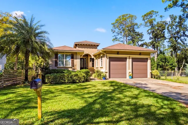 a front view of a house with a yard