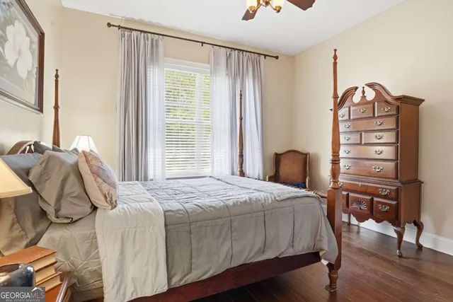 a bedroom with a bed a table and chair