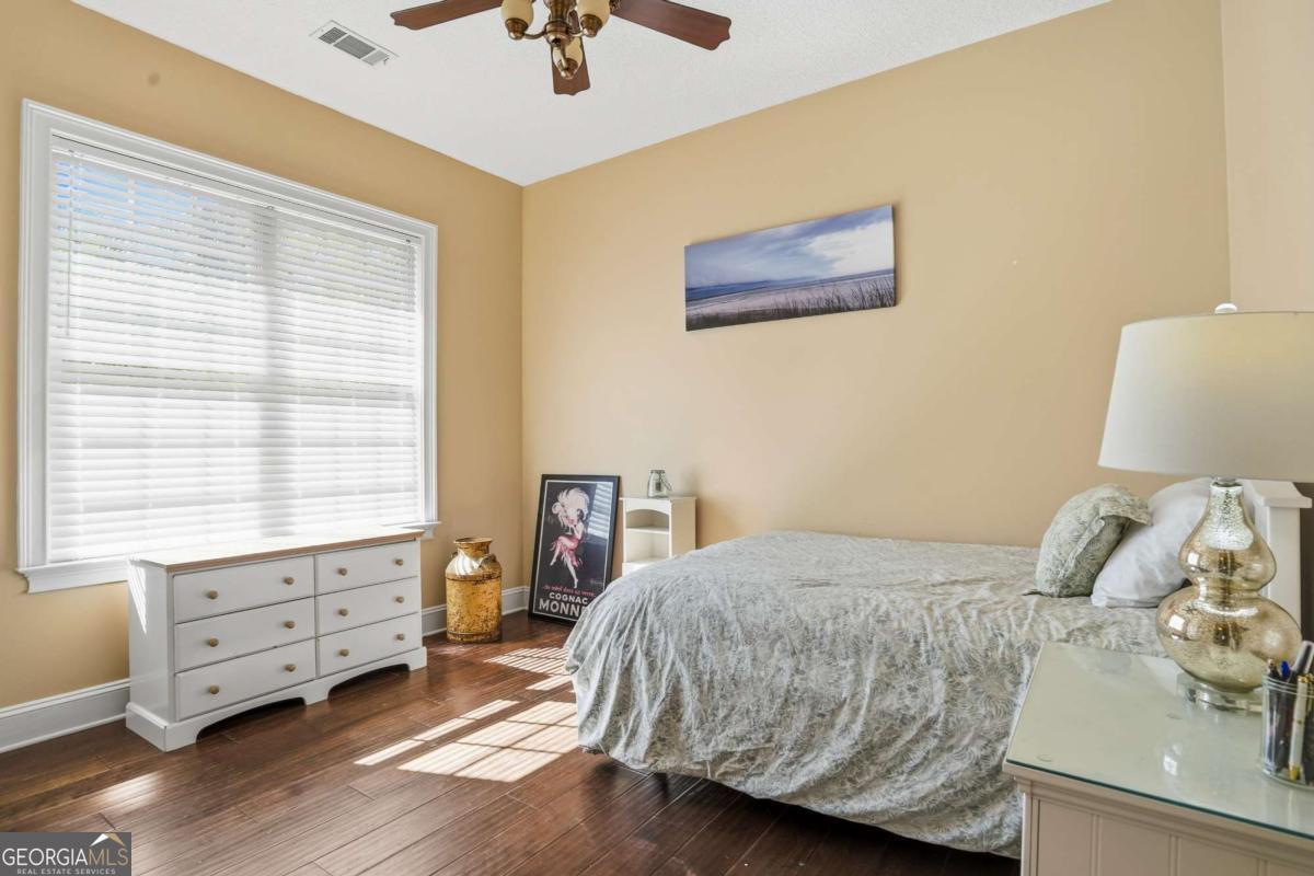 135 Stewart Street St. Simons, GA 31522 - Photo 16 of 27 a bedroom with a bed and a window