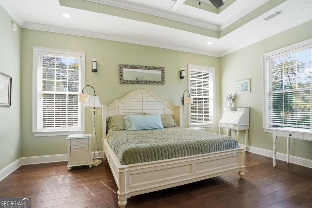 135 Stewart Street St. Simons, GA 31522 - Photo 17 of 27 a bed sitting in a bedroom next to a window