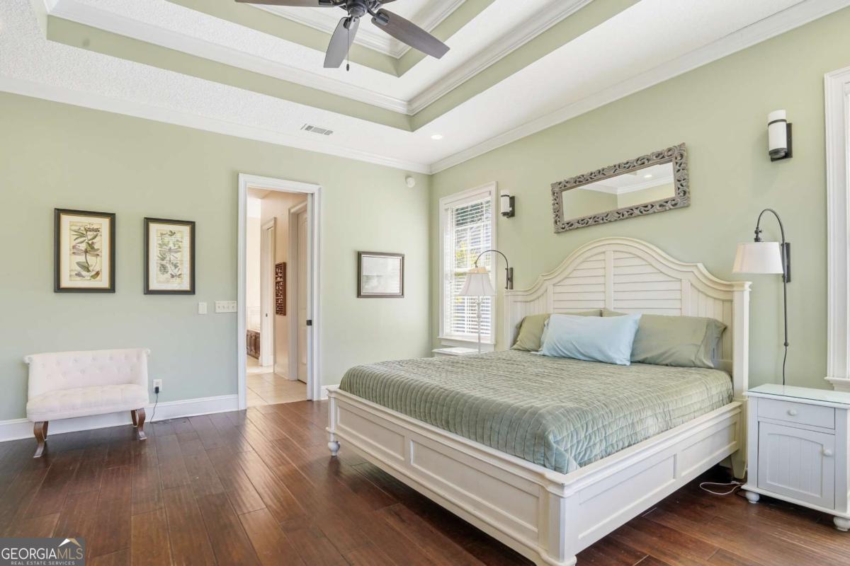 135 Stewart Street St. Simons, GA 31522 - Photo 18 of 27 a bedroom with a bed and a table