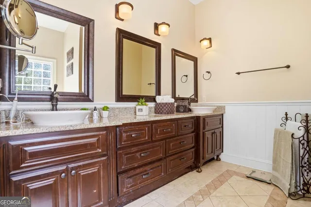 a bathroom with a sink double vanity and a mirror