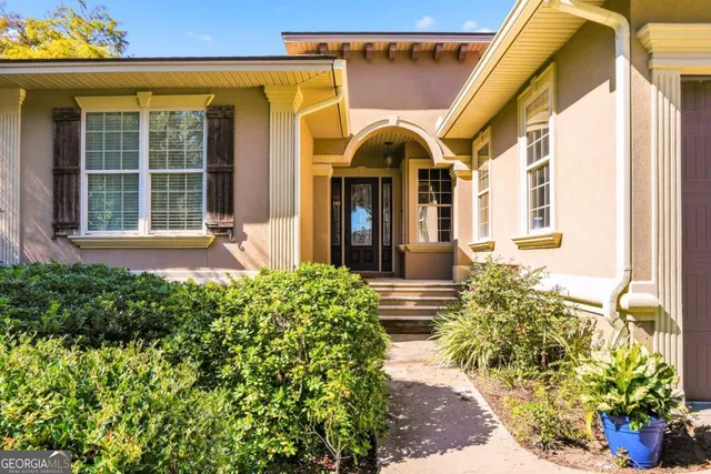 a view of a house with potted plants