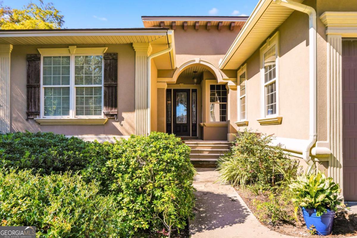 135 Stewart Street St. Simons, GA 31522 - Photo 2 of 27 a view of a house with potted plants