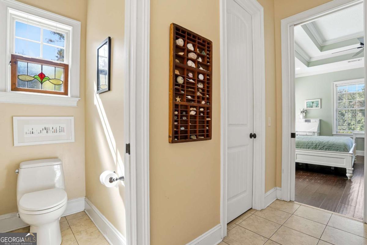 135 Stewart Street St. Simons, GA 31522 - Photo 22 of 27 a bathroom with a toilet and a shower