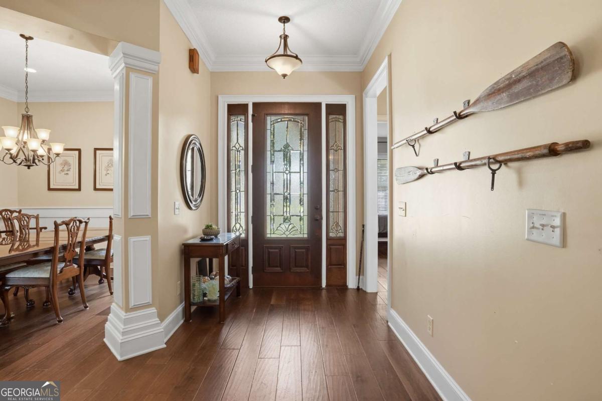 135 Stewart Street St. Simons, GA 31522 - Photo 3 of 27 a view of a livingroom with furniture wooden floor mirror and fan