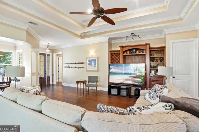 a living room with furniture and a wooden floor