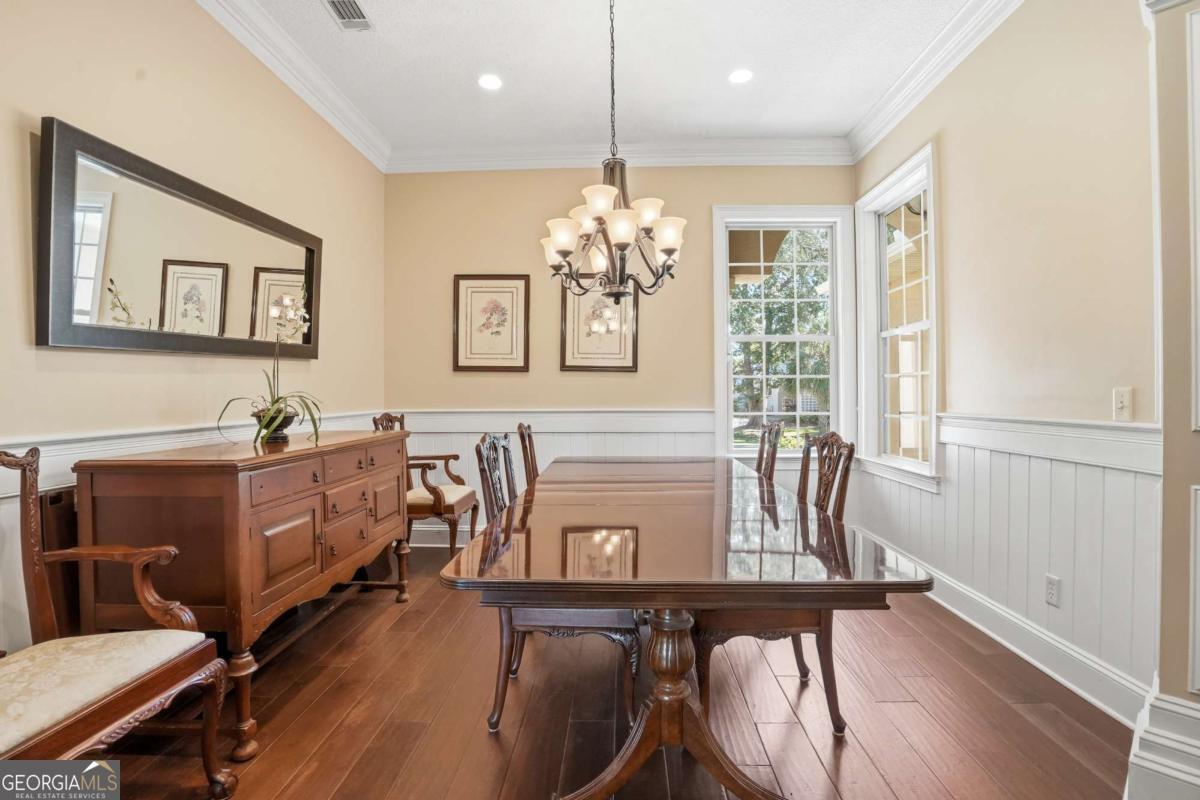 135 Stewart Street St. Simons, GA 31522 - Photo 7 of 27 a view of a dining room with furniture window and wooden floor