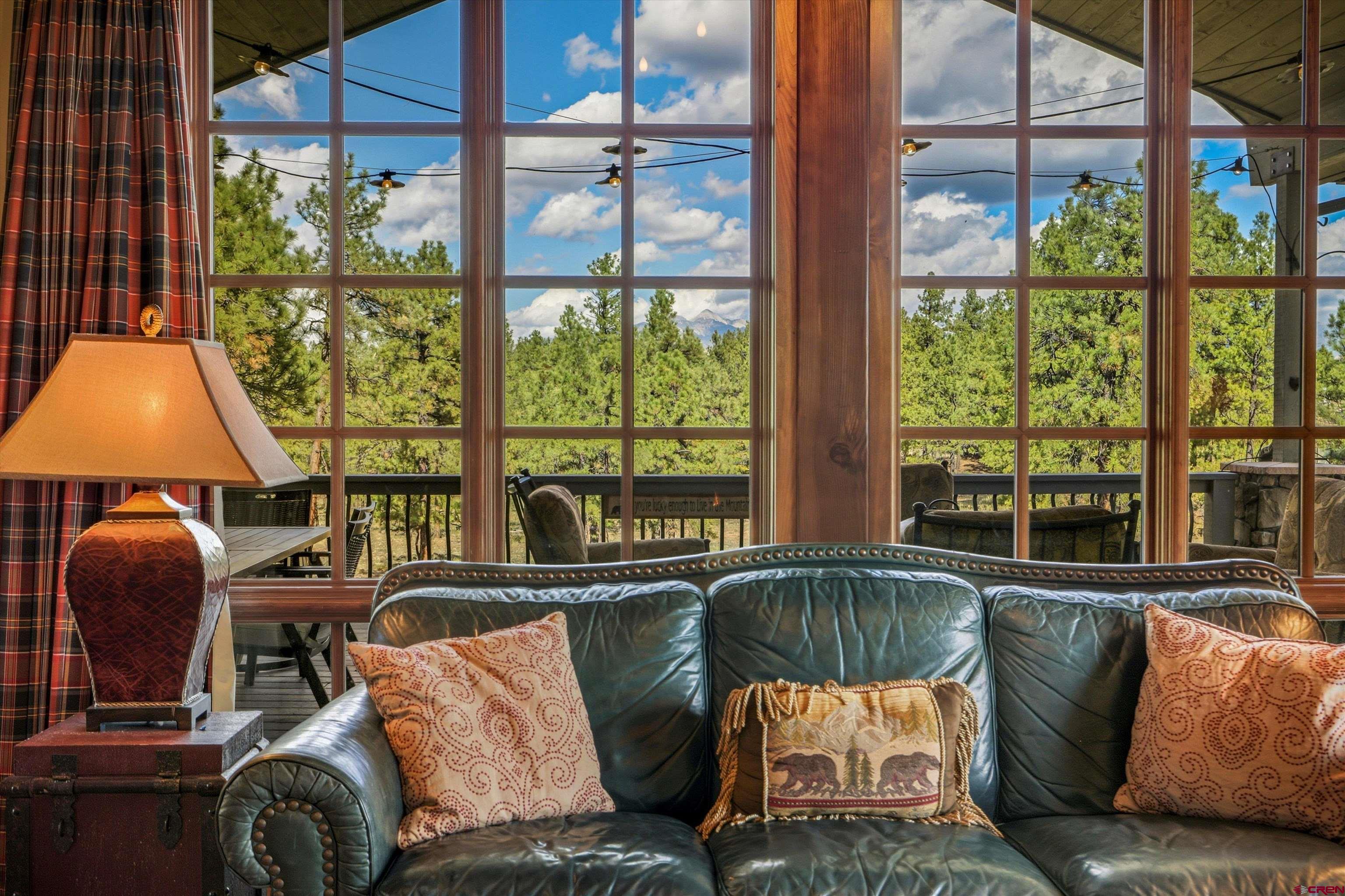 171 South Squaw Canyon Place Pagosa Springs, CO 81147 - Photo 12 of 45 a living room with furniture and a large window