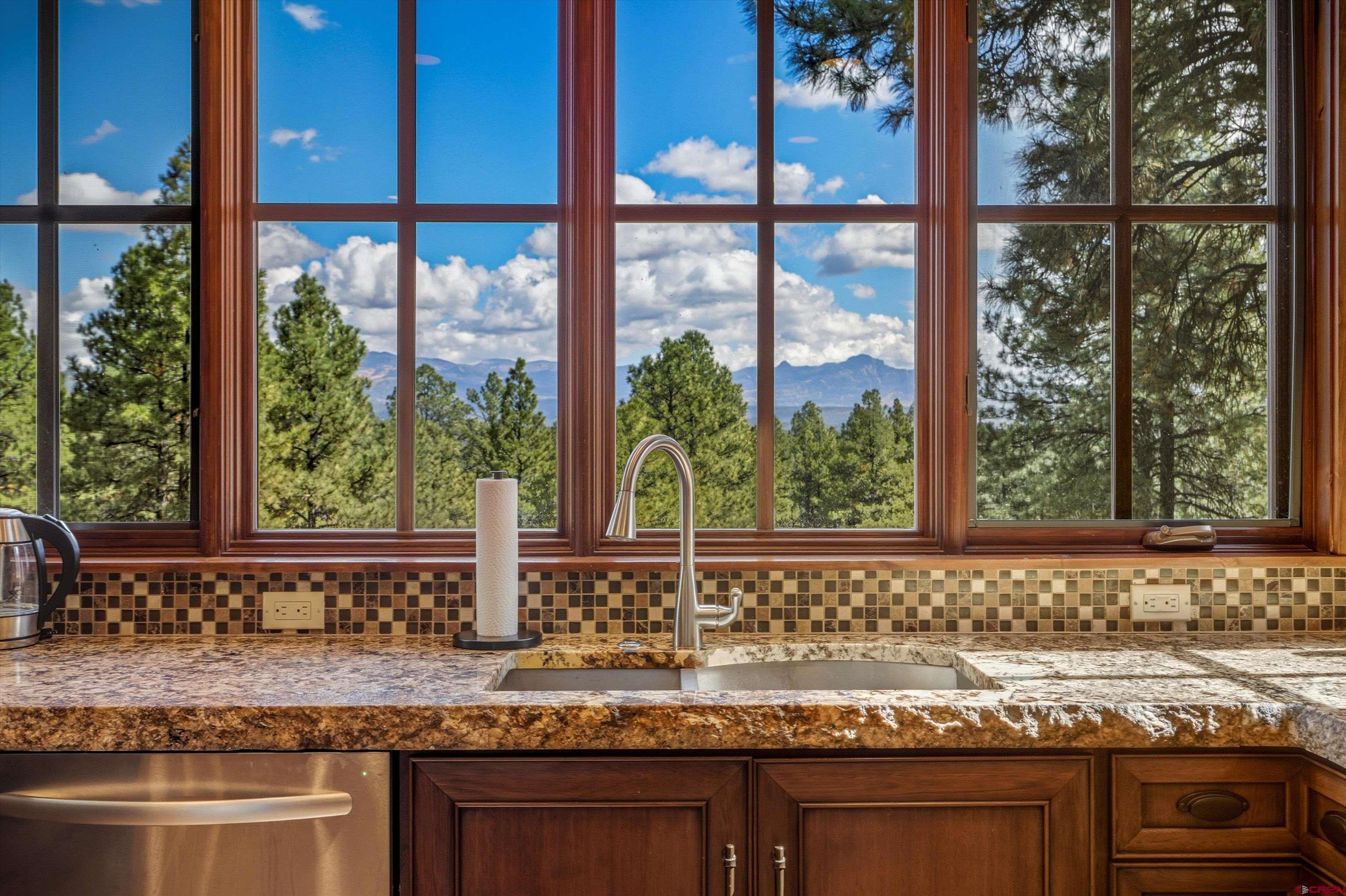 171 South Squaw Canyon Place Pagosa Springs, CO 81147 - Photo 15 of 45 a bathroom with a granite countertop sink and mirror