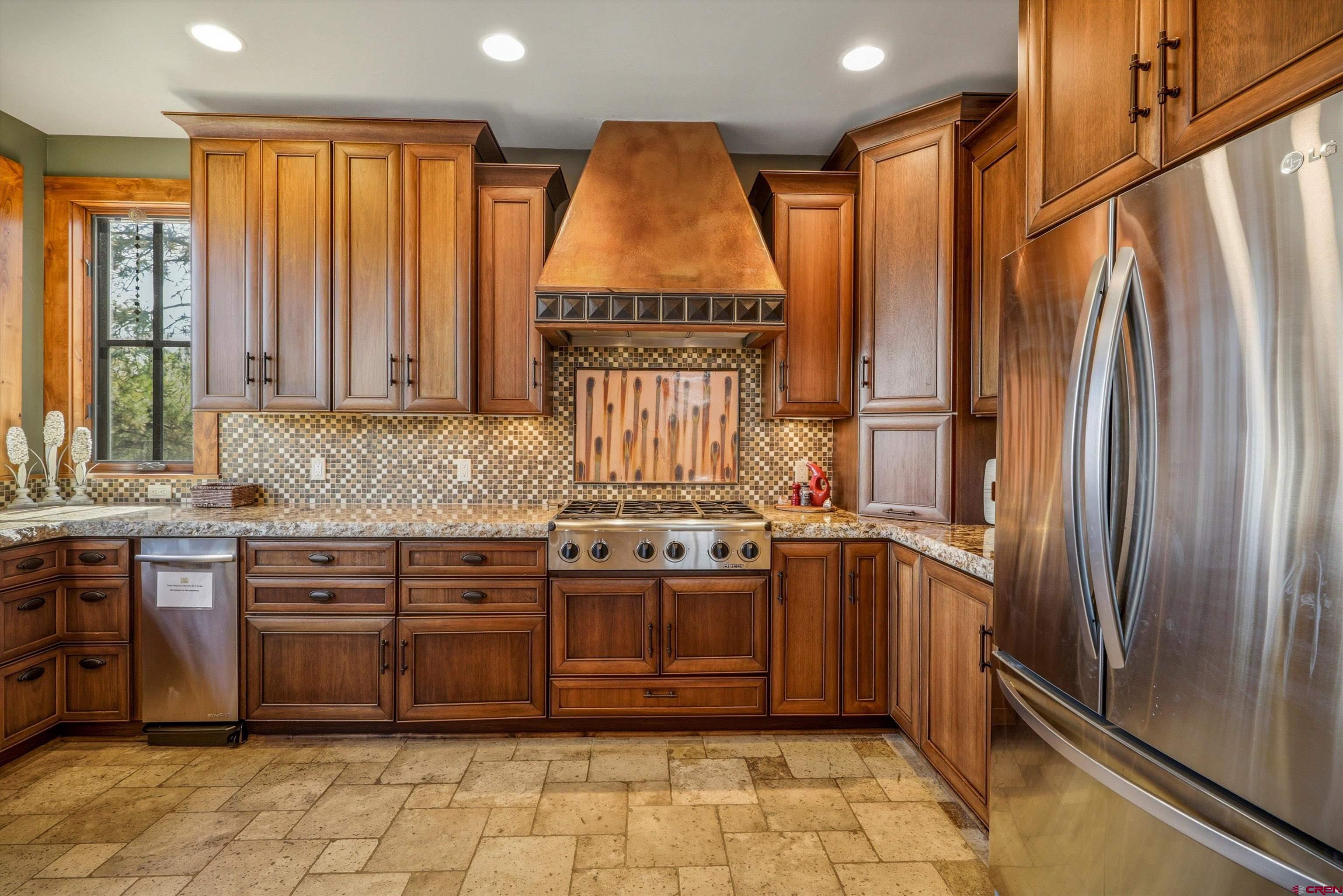 171 South Squaw Canyon Place Pagosa Springs, CO 81147 - Photo 16 of 45 a kitchen with stainless steel appliances granite countertop a refrigerator and a stove