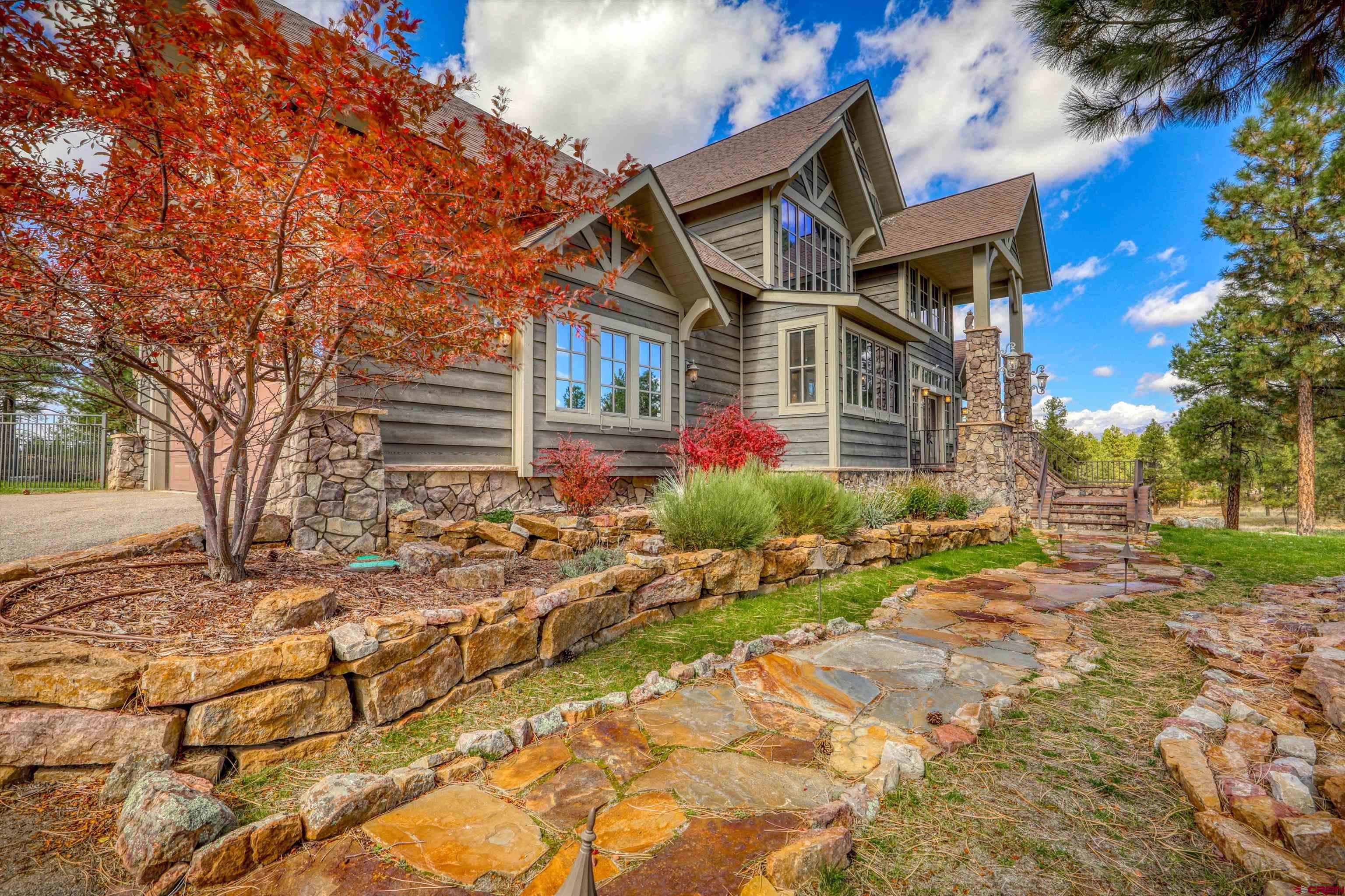 171 South Squaw Canyon Place Pagosa Springs, CO 81147 - Photo 2 of 45 a front view of a house with a yard
