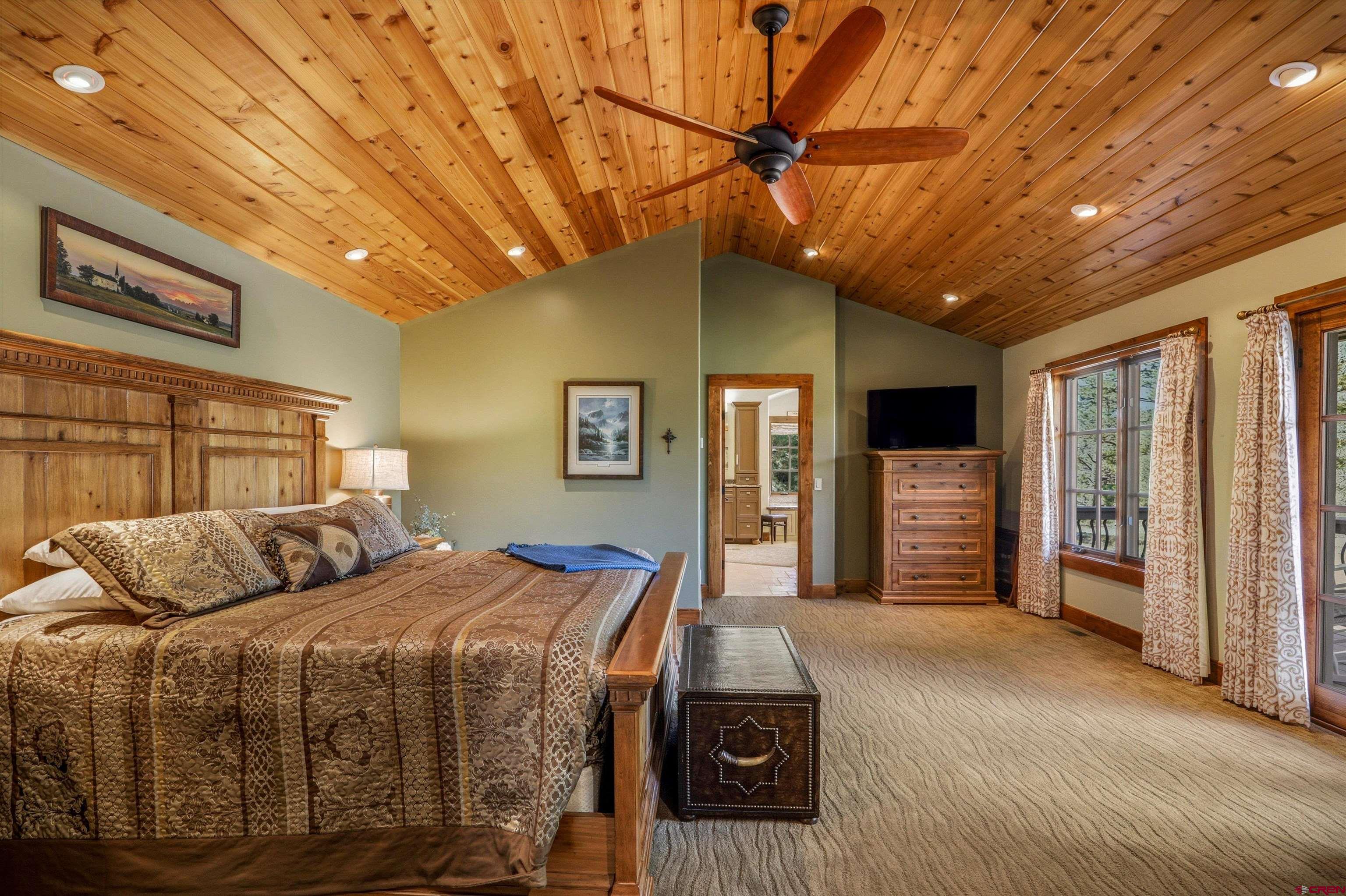 171 South Squaw Canyon Place Pagosa Springs, CO 81147 - Photo 22 of 45 a bedroom with bed and wooden floor