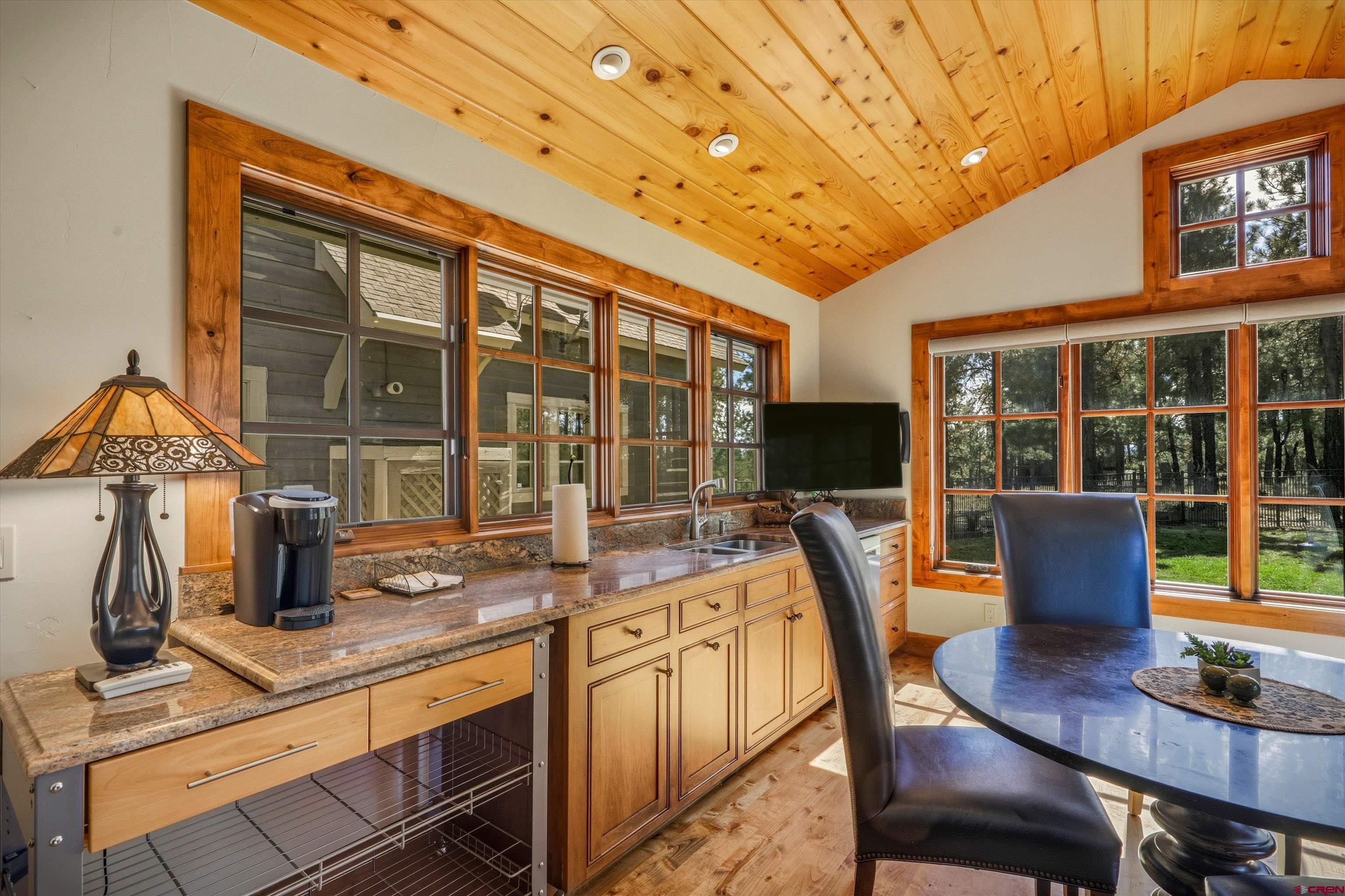 171 South Squaw Canyon Place Pagosa Springs, CO 81147 - Photo 28 of 45 a view of a dining room with furniture window and outside view