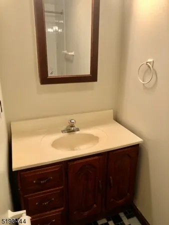 a bathroom with a sink vanity and mirror