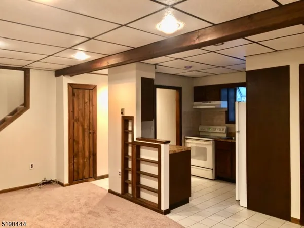 a view of a hallway with wooden shelves