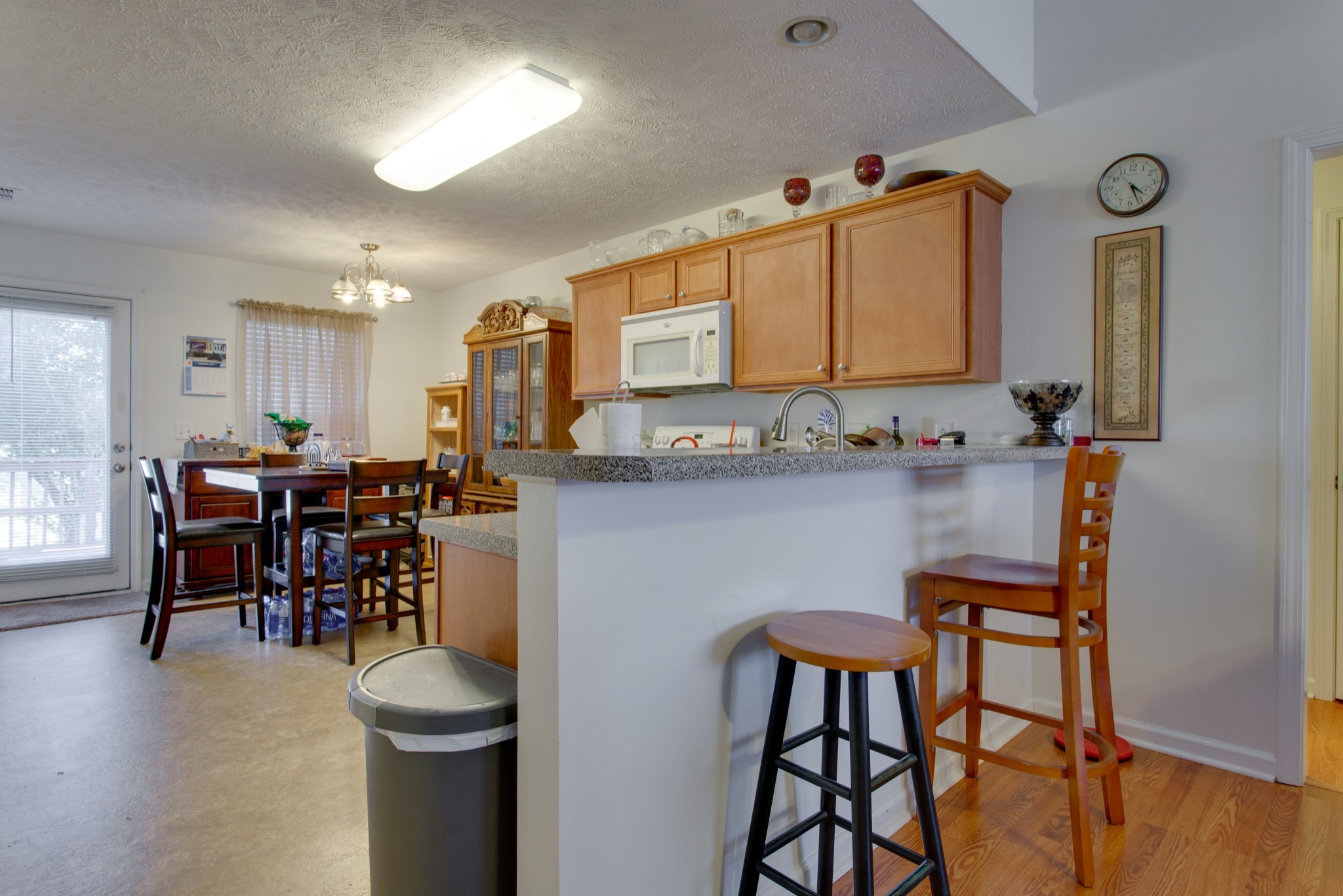 2214 Cason Trail Murfreesboro, TN 37128 - Photo 5 of 13 a kitchen with kitchen island a dining table chairs cabinets and sink