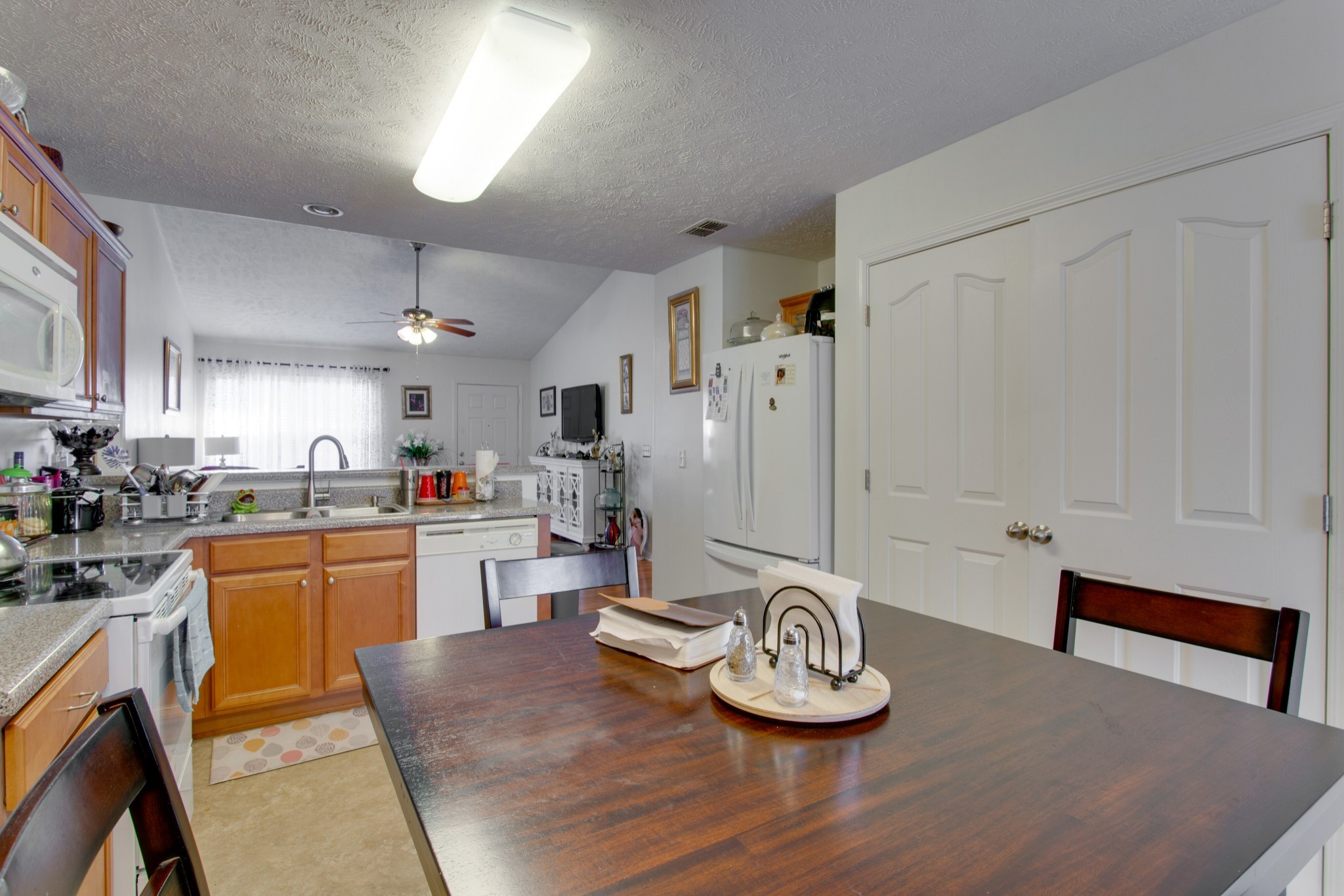 2214 Cason Trail Murfreesboro, TN 37128 - Photo 7 of 13 a kitchen with sink refrigerator dining table and chairs