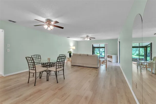 a view of a dining room with furniture and wooden floor