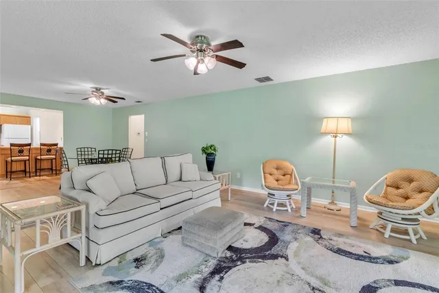 a living room with furniture a table and chair