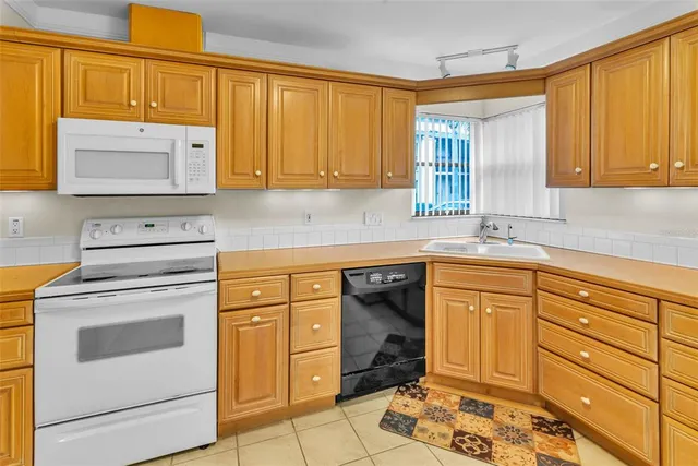 a kitchen with granite countertop cabinets stainless steel appliances and sink