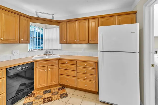 a kitchen with a refrigerator and a sink