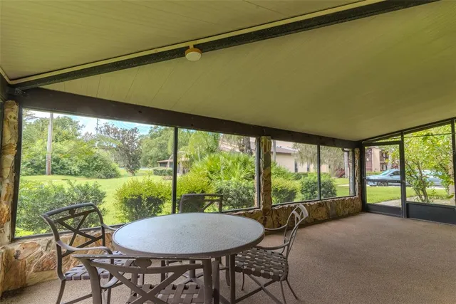 a living room with a floor to ceiling window and table