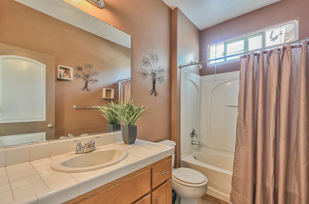 1013 Capri Way Salinas, CA 93905 - Photo 20 of 23 a bathroom with a granite countertop sink toilet and shower