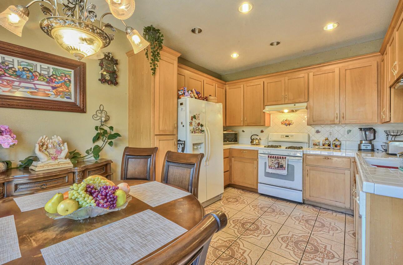 1013 Capri Way Salinas, CA 93905 - Photo 9 of 23 a kitchen with kitchen island stainless steel appliances a stove a sink and a refrigerator
