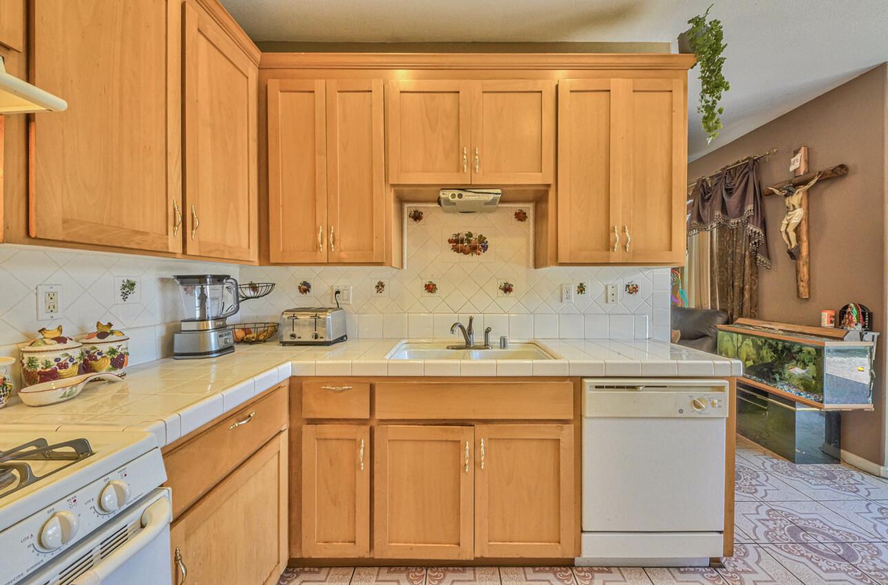 1013 Capri Way Salinas, CA 93905 - Photo 10 of 23 a kitchen with stainless steel appliances granite countertop a sink stove and cabinets