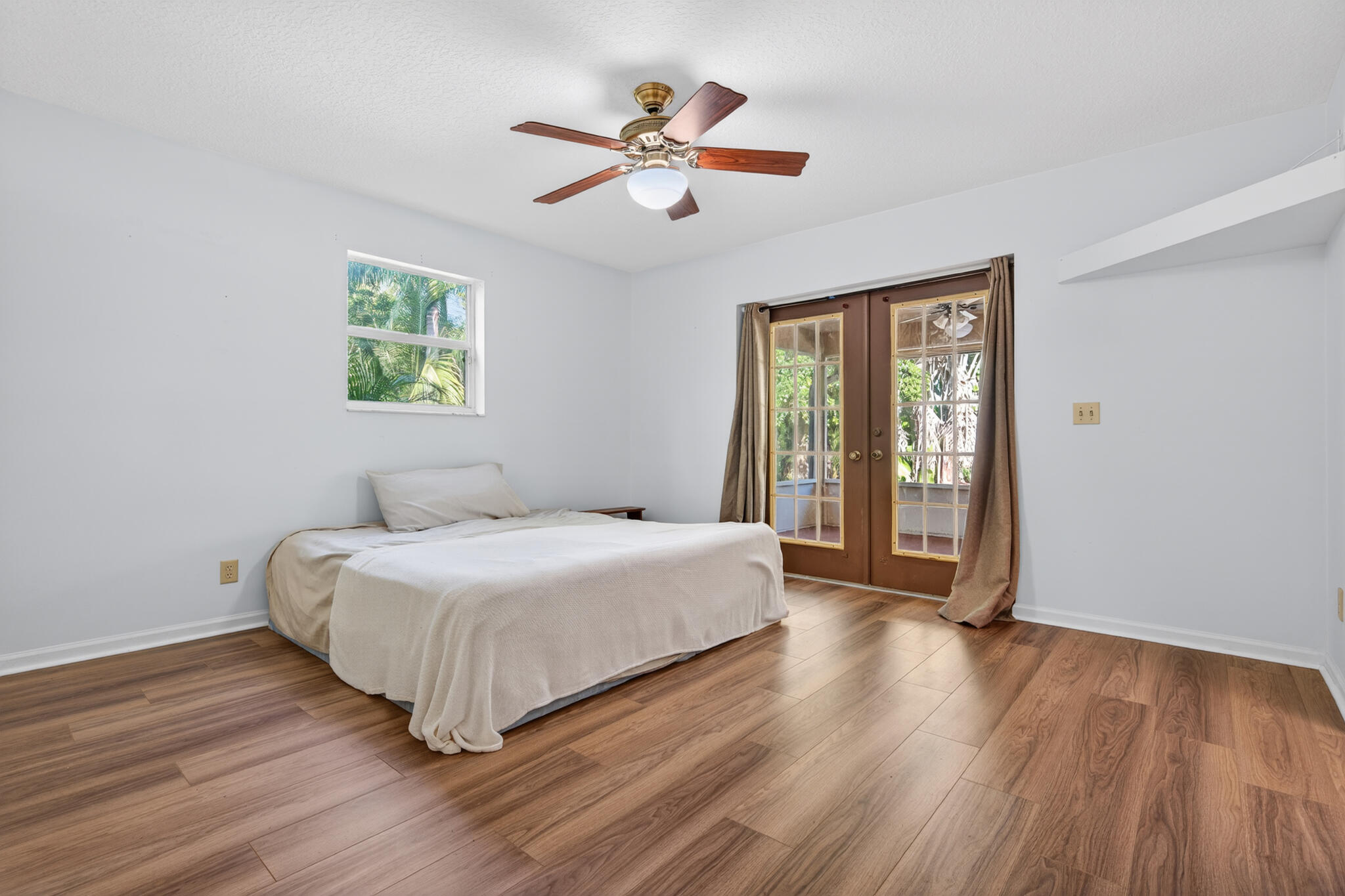 17889 62nd Road North The Acreage, FL 33470 - Photo 13 of 32 a bedroom with a bed and a large window