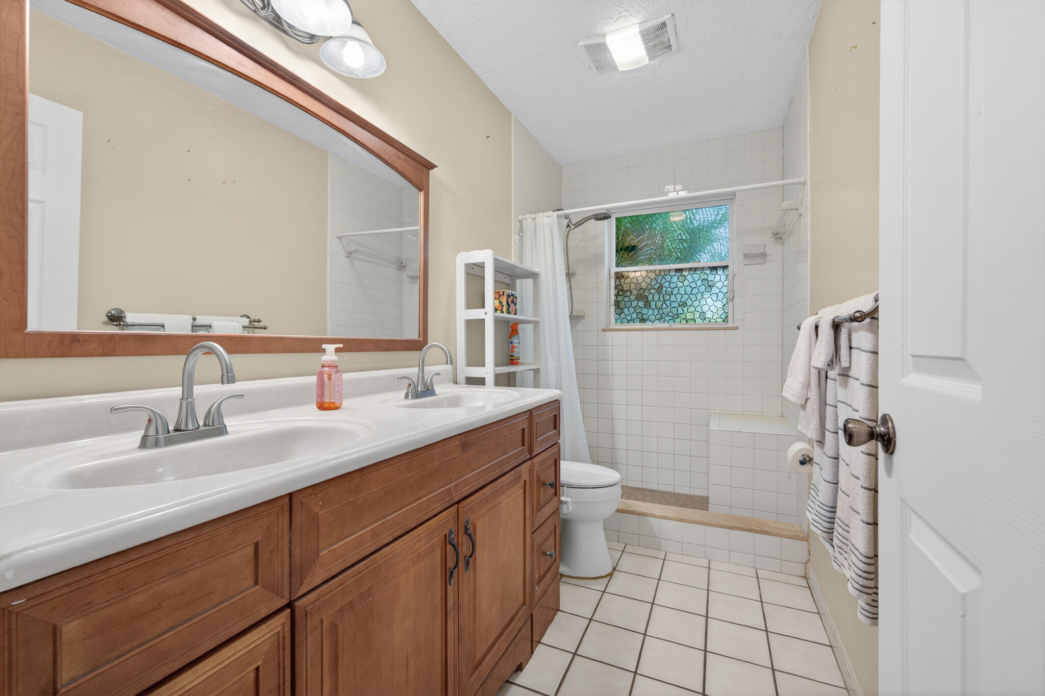17889 62nd Road North The Acreage, FL 33470 - Photo 15 of 32 a bathroom with a sink a toilet a mirror and shower
