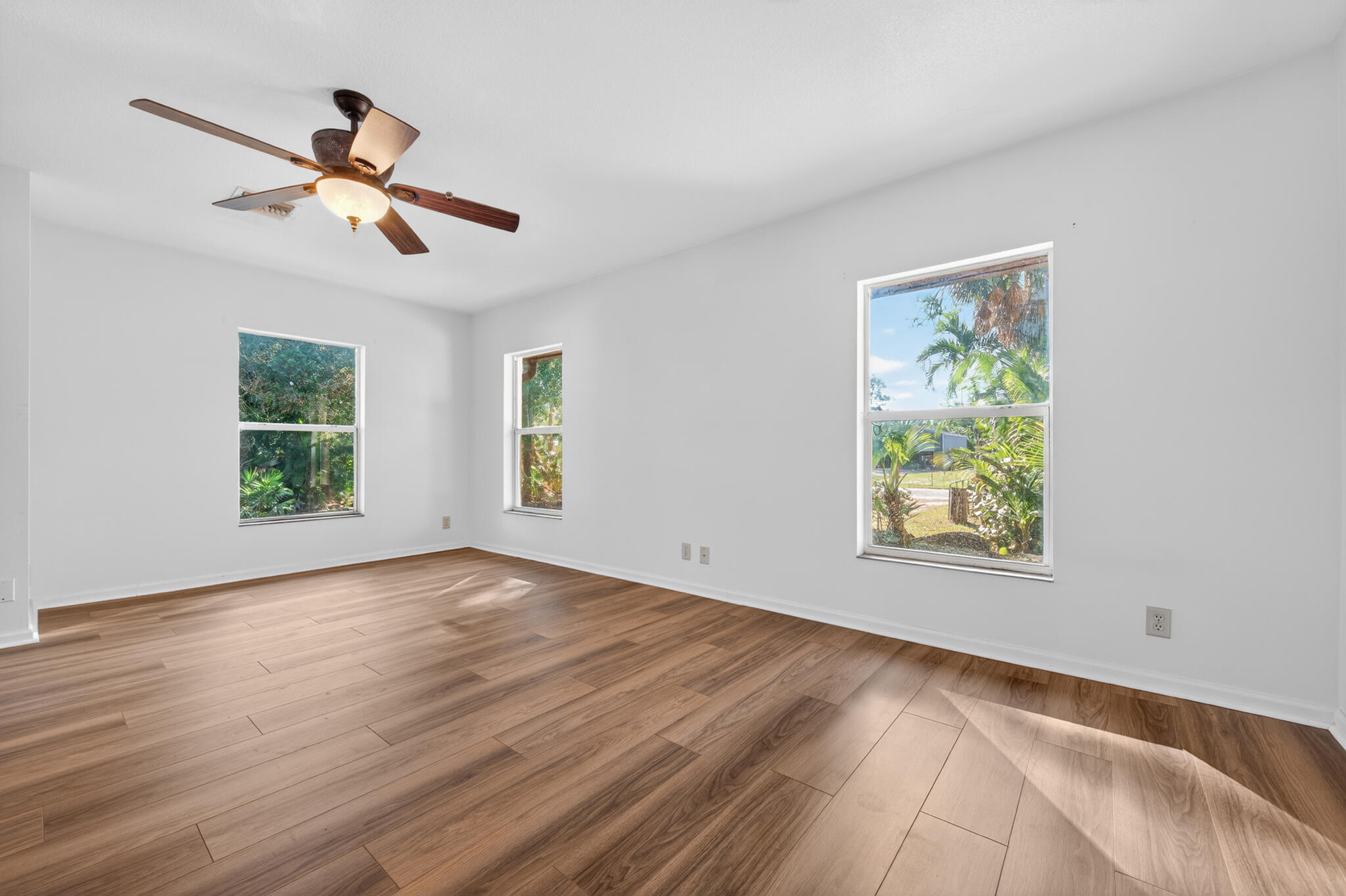 17889 62nd Road North The Acreage, FL 33470 - Photo 16 of 32 a view of empty room with wooden floor and fan