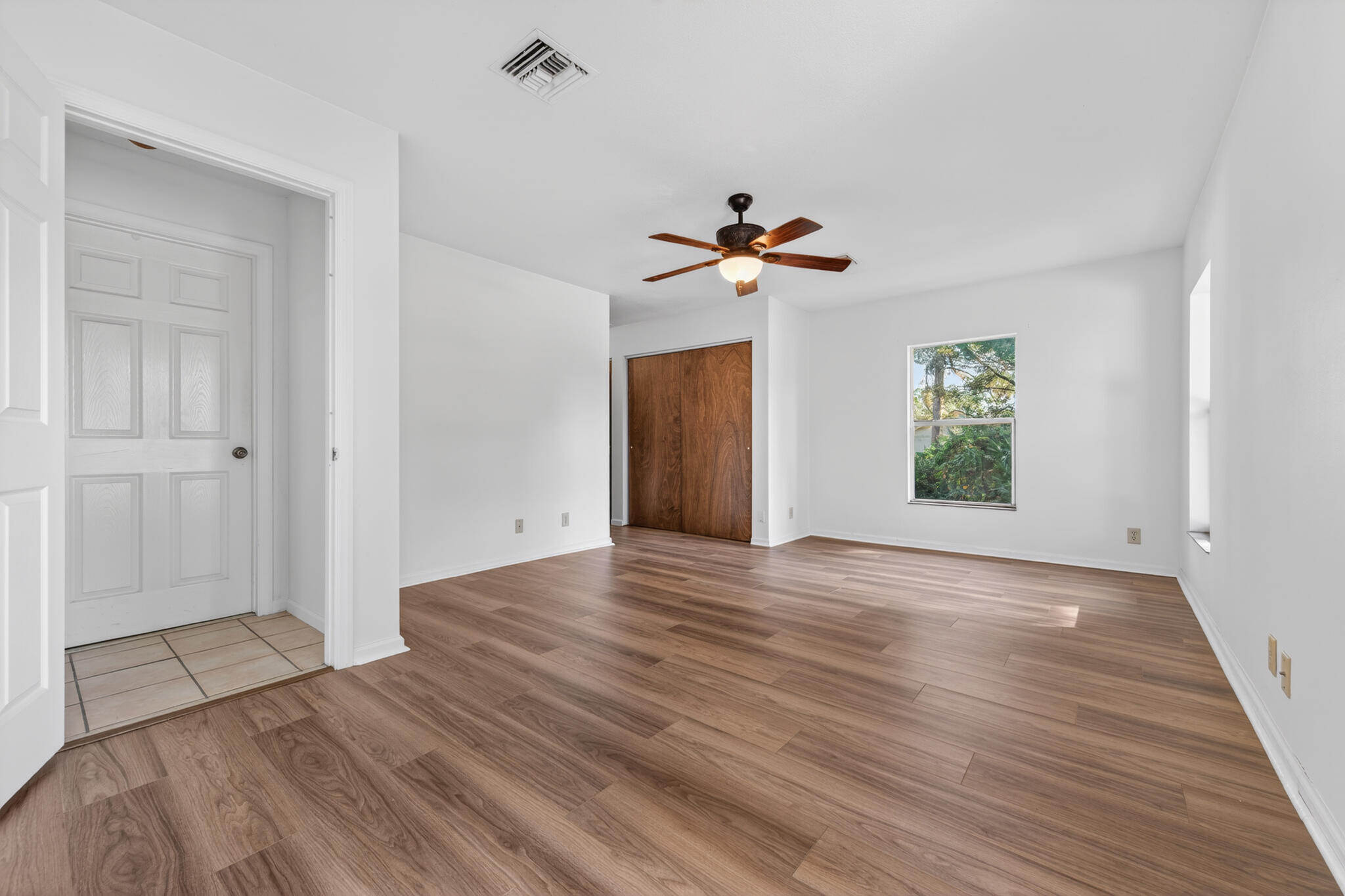17889 62nd Road North The Acreage, FL 33470 - Photo 17 of 32 a view of empty room with wooden floor and fan