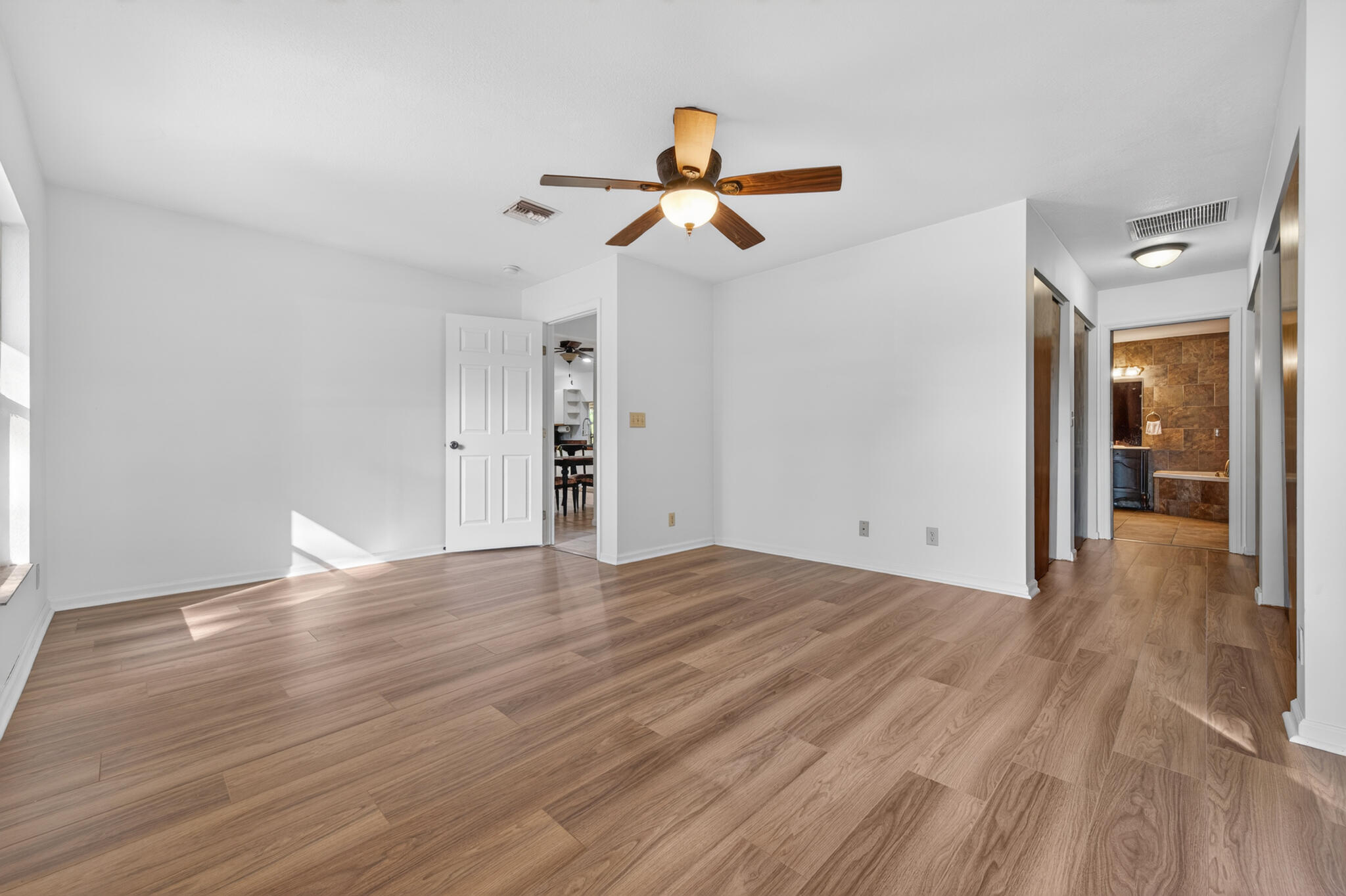 17889 62nd Road North The Acreage, FL 33470 - Photo 18 of 32 a view of empty room with wooden floor and fan