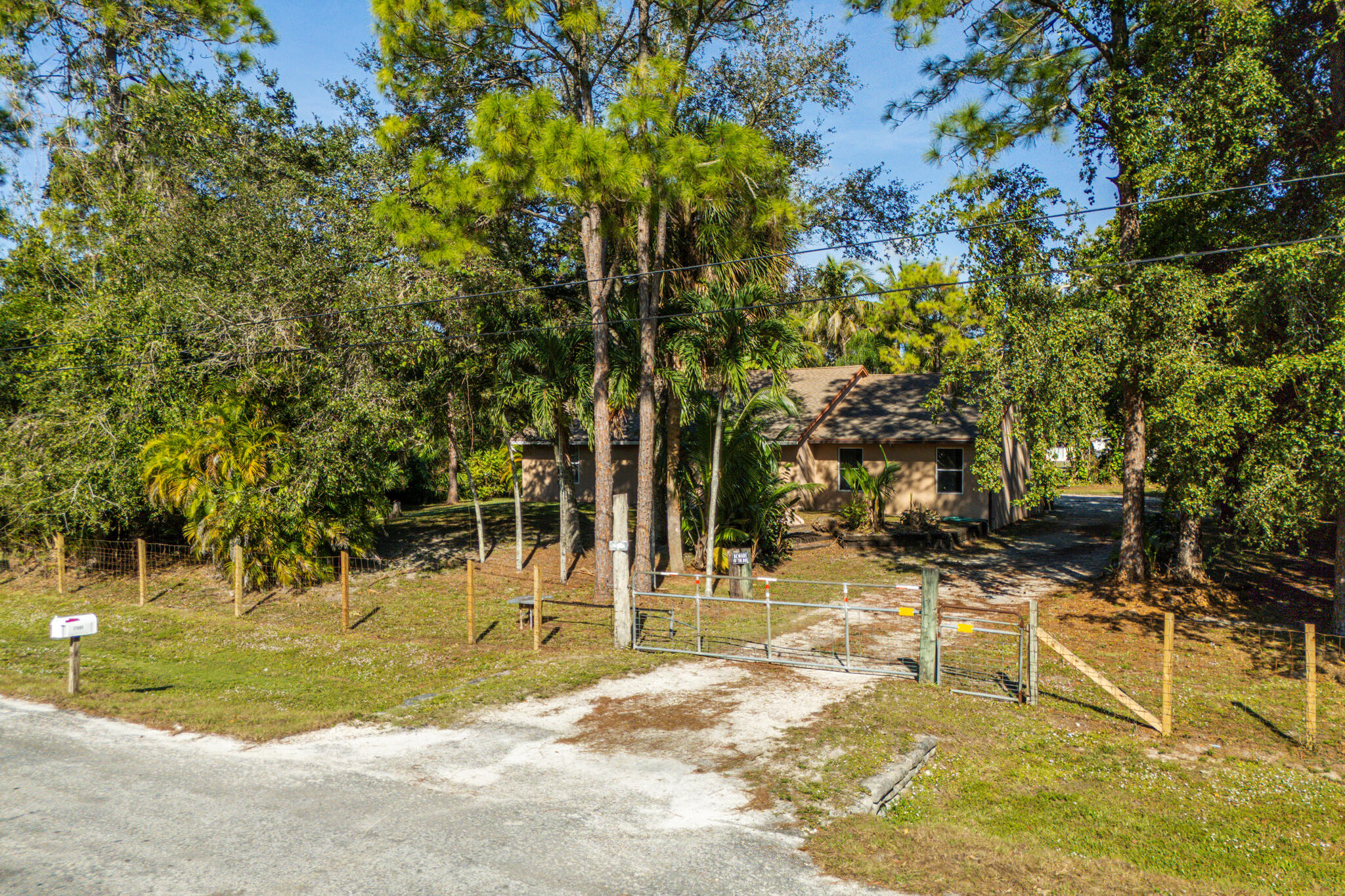 17889 62nd Road North The Acreage, FL 33470 - Photo 3 of 32 a view of a swimming pool with a lawn chairs and plants