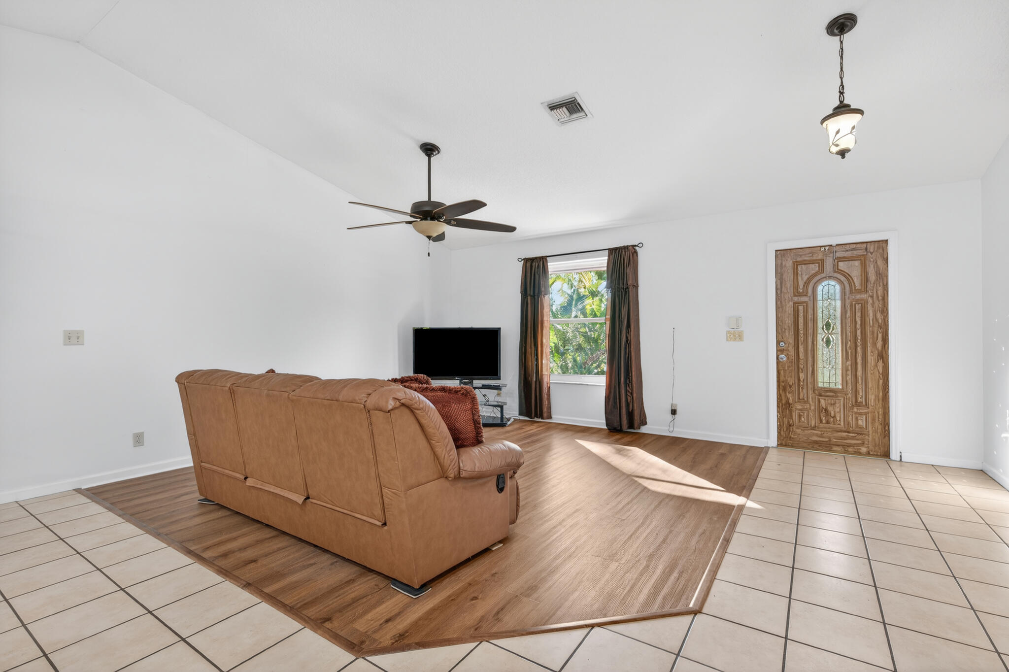 17889 62nd Road North The Acreage, FL 33470 - Photo 7 of 32 a living room with furniture and a flat screen tv