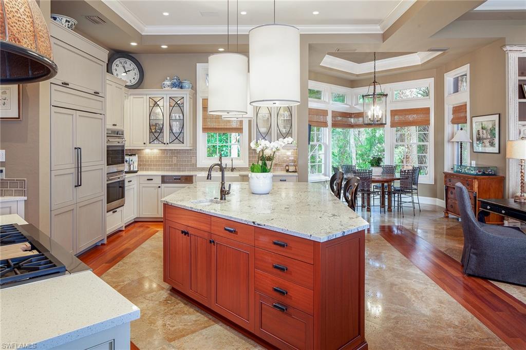 1205 Pocantico Lane Naples, FL 34110 - Photo 16 of 35 a kitchen with stainless steel appliances granite countertop a stove and refrigerator