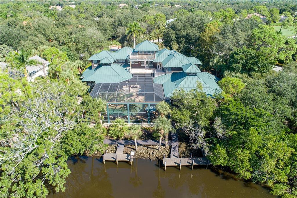 1205 Pocantico Lane Naples, FL 34110 - Photo 18 of 35 an aerial view of a house with a garden and lake view