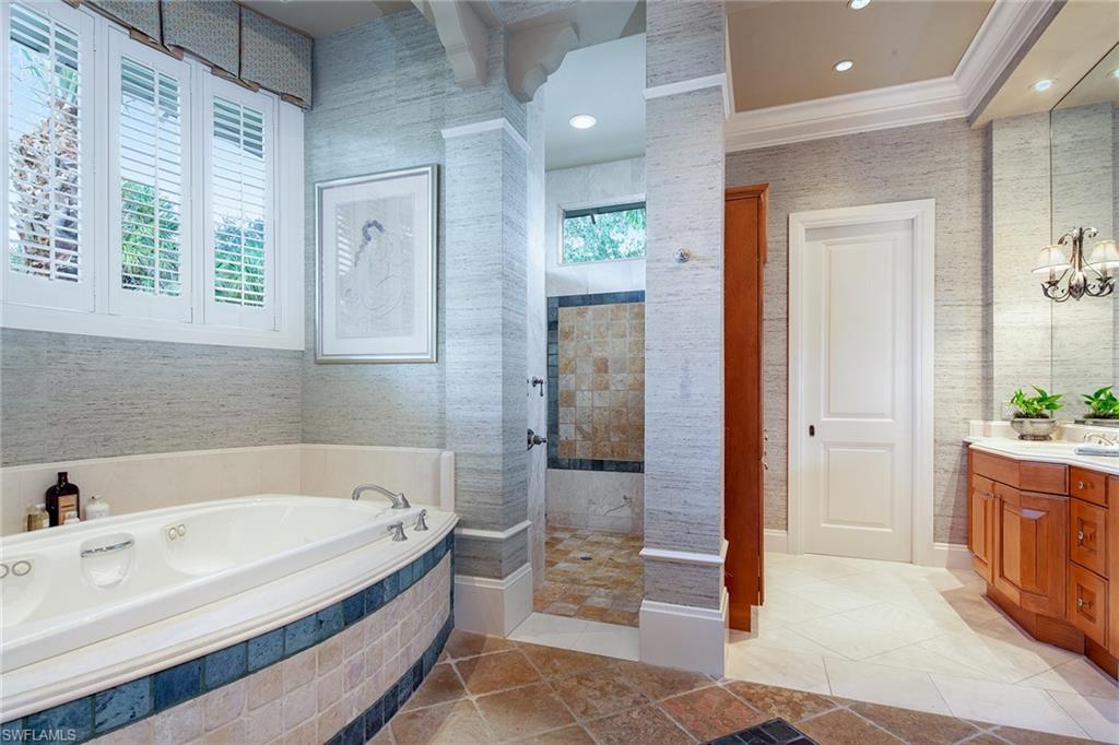 1205 Pocantico Lane Naples, FL 34110 - Photo 27 of 35 a bathroom with a bathtub and a shower
