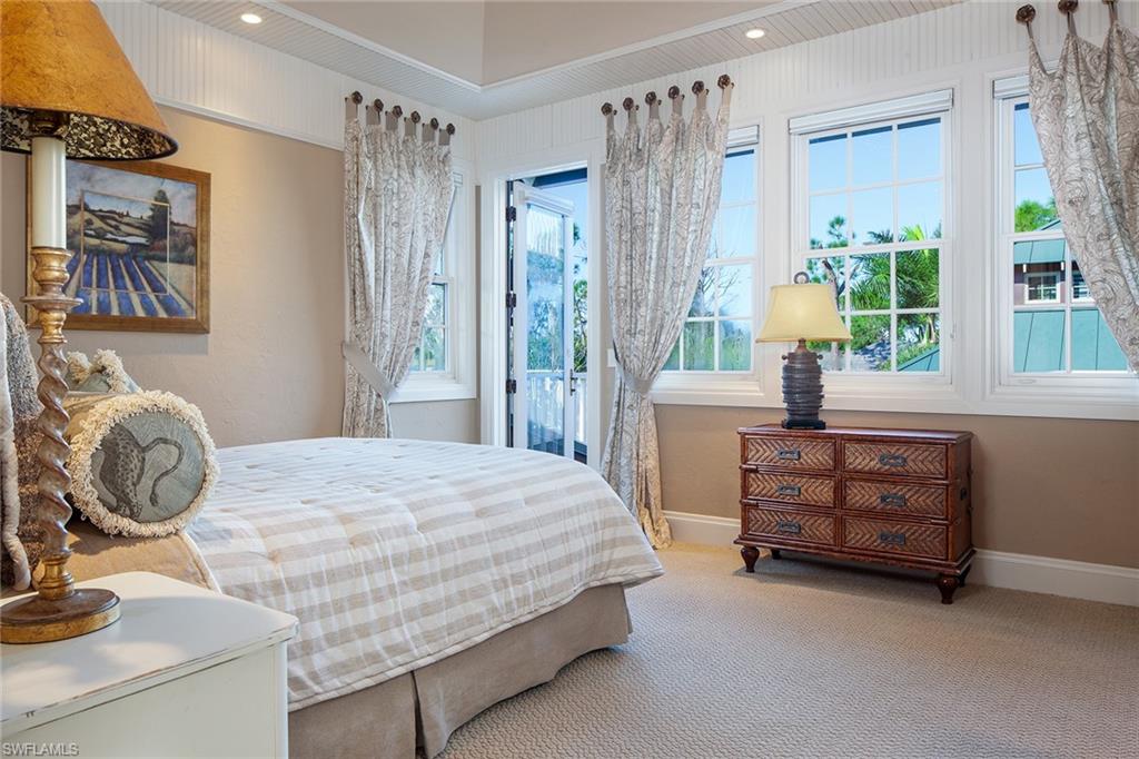 1205 Pocantico Lane Naples, FL 34110 - Photo 29 of 35 a bedroom with a bed and a dresser