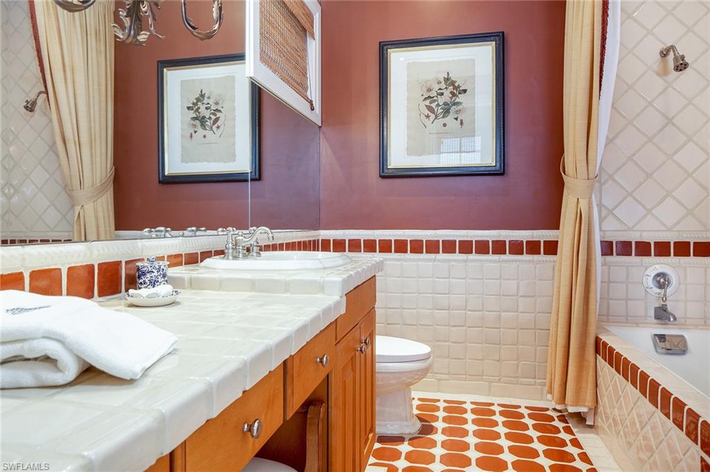 1205 Pocantico Lane Naples, FL 34110 - Photo 33 of 35 a bathroom with a sink and a bathtub