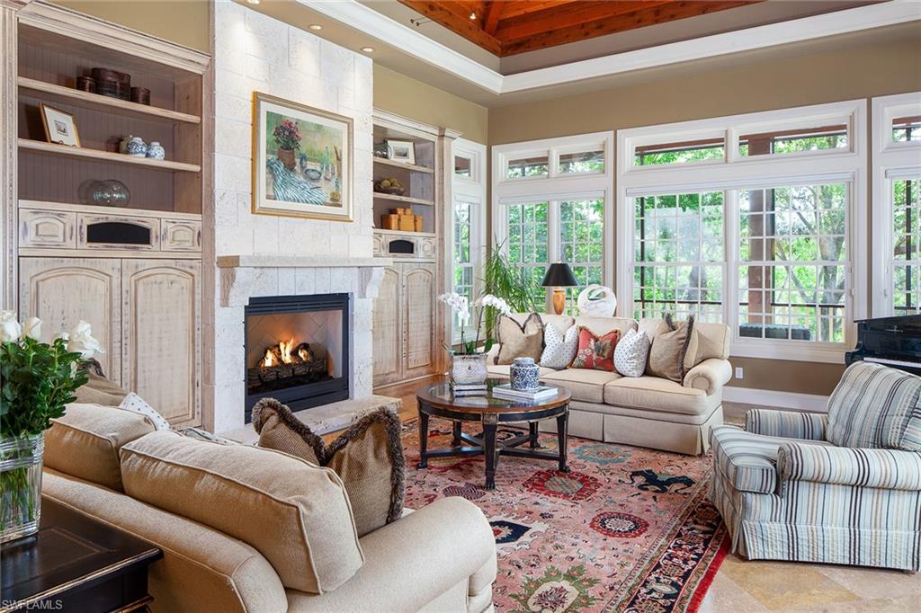 1205 Pocantico Lane Naples, FL 34110 - Photo 9 of 35 a living room with furniture and a fireplace